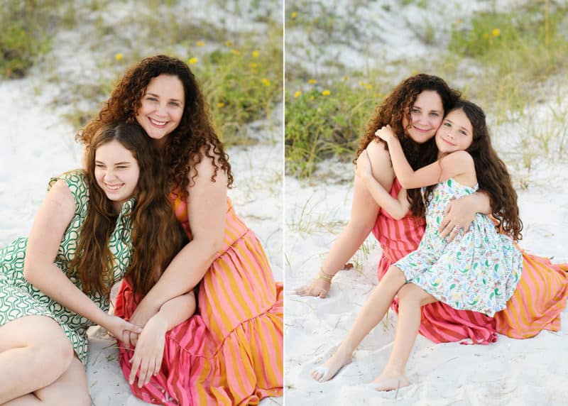 mom with two young daughters sitting on the beach in Florida taking vacation photos