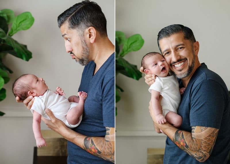 dad holding newborn baby and making funny faces, smiling during at-home photo session