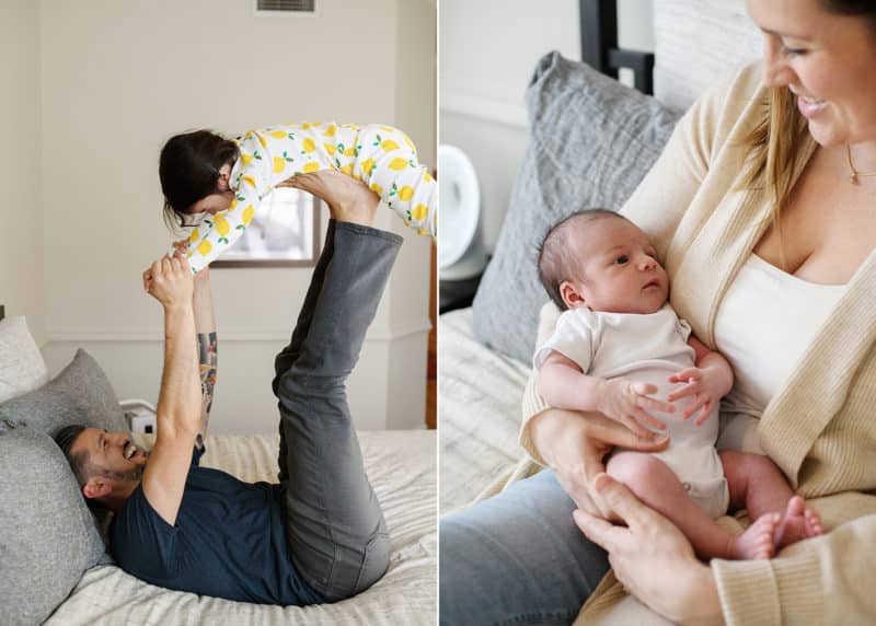 dad holding young girl up on his toes, mom holding newborn baby in bed