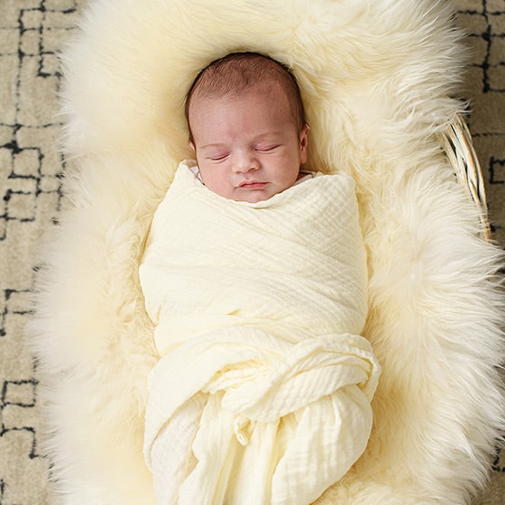 newborn baby laying on a sherpa rug during at-home session in sacramento california