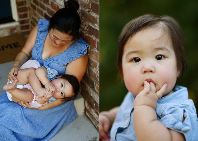 mom holding baby daughter by front door, young girl staring at the camera during family photo session