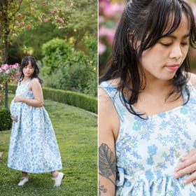 pregnant woman holding her belly in a flower garden in sacramento california