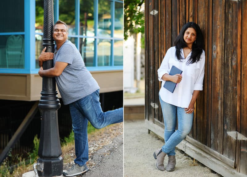 mom holding a journal leaning on a wooden wall, dad hugging a lamp post being silly in folsom california