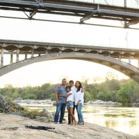 taking family photos in the natural light under a bridge in folsom california