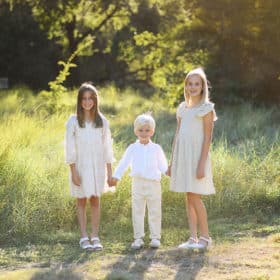 three young siblings holding hands during family photos in Davis, California