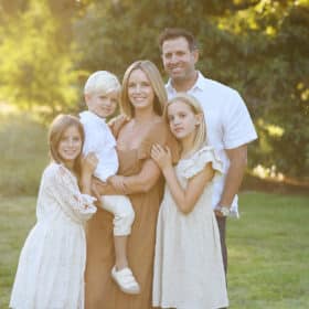 family of five wearing neutral clothes during golden hour family session in davis california