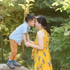mom and son touching foreheads and giggling together during family photos