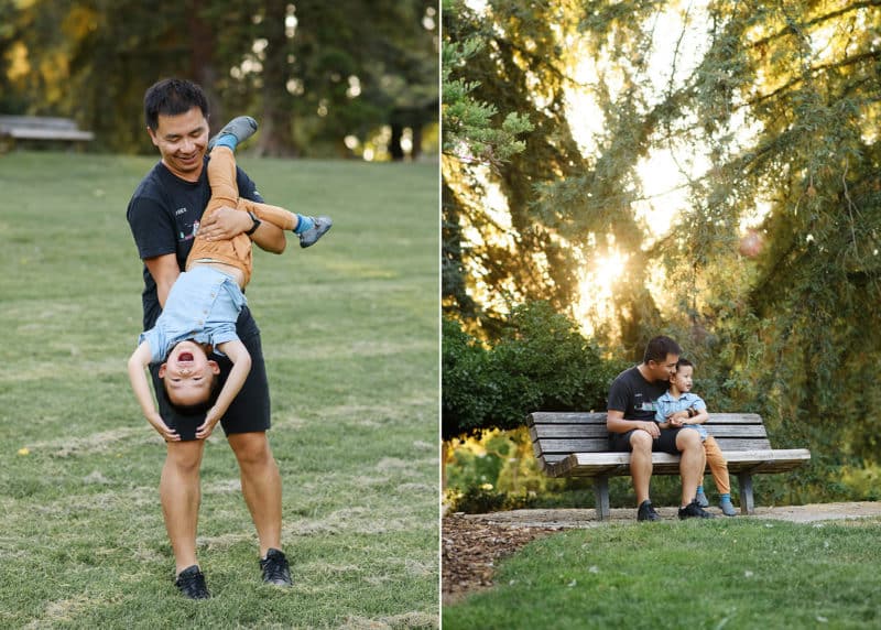 dad holding young son upside down and laughing, sitting on a bench together during golden hour in davis california