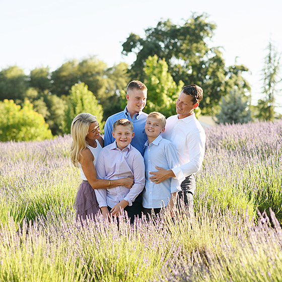 family of five standing in a lavender field during summer photo session in newcastle california
