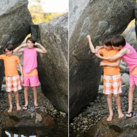 two young boys standing on rocks in folsom lake and flexing their muscles