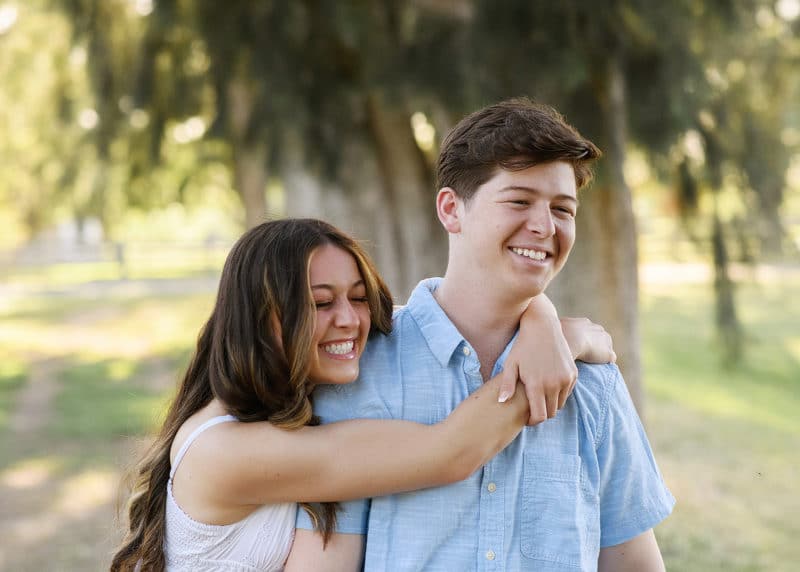 sister hugging brother during senior portraits in sacramento california