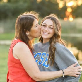 mom kissing daughter on the cheek during senior portraits in sacramento california