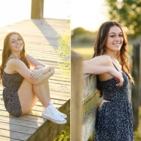 senior in high school posing on a dock wearing a blue dress, posing against a wooden fence