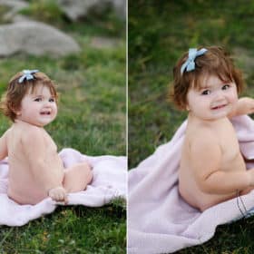 baby girl sitting on a blanket in the grass looking at the photographer during family photos in granite bay california