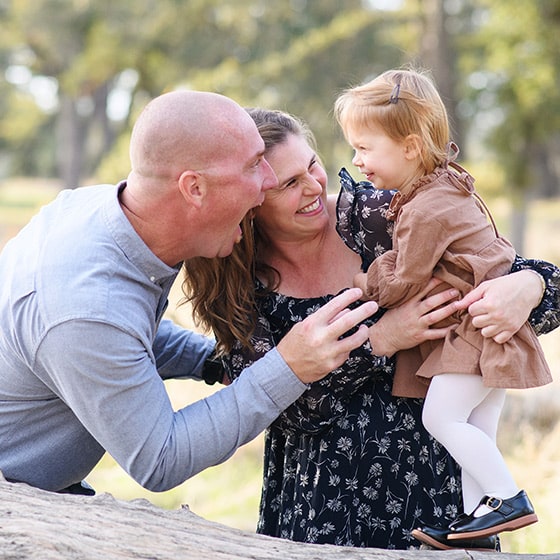 folsom photographer taking maternity photos with a family of three, laughing together and making silly faces