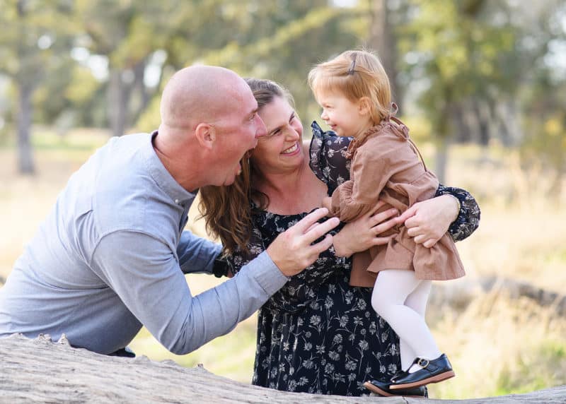 folsom photographer taking maternity photos with a family of three, laughing together and making silly faces