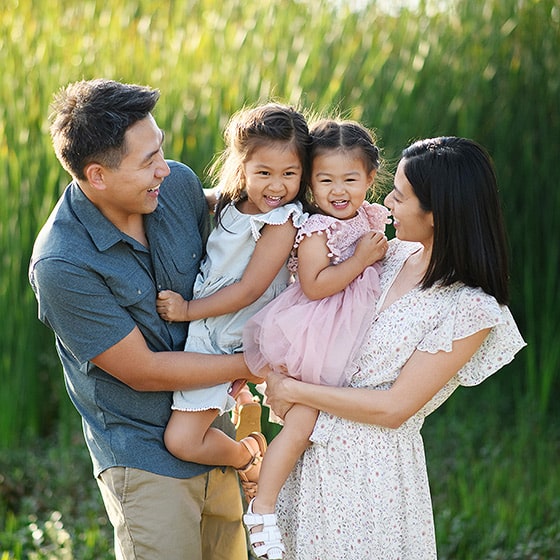 family of four giggling and smiling during family photos in sacramento california