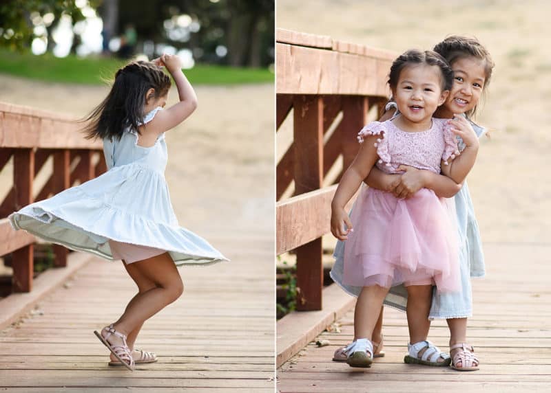 two young sisters hugging, dancing in a flowy dress