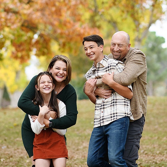 mom and dad tickling children and laughing during photo session in sacramento california