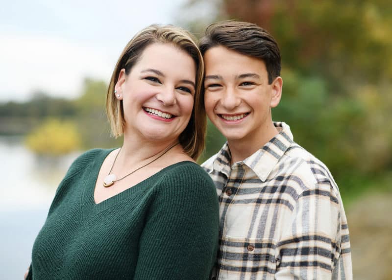 mom and young son during fall family pictures in front of the sacramento river