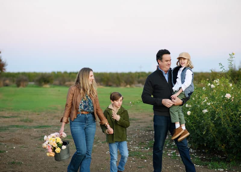 yuba city photographer - family of four taking fall pictures in flower field in yuba city california