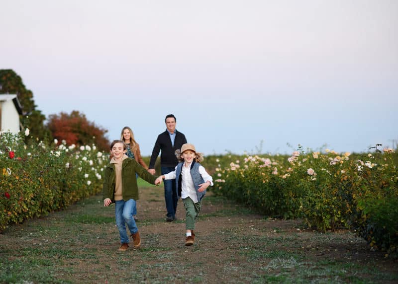 brothers running and holding hands during family photos in yuba city california