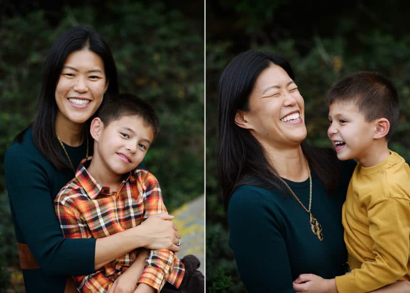 mom holding young son on her lap and smiling at the camera; laughing together during fall family pictures with jill carmel