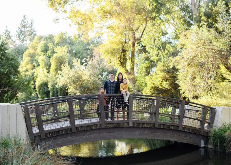 taking fall family pictures on a bridge in the davis california arboretum with natural lighting 