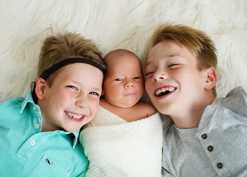 two brothers with newborn baby sibling during studio session with sacramento photographer jill carmel