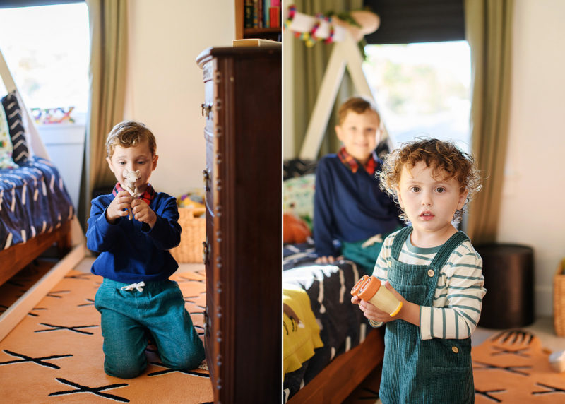 two young boys playing with toys in their room during sacramento at-home photo session