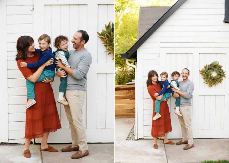 family of four taking pictures in front of white barn during at-home family session in sacramento california